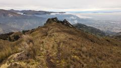 rocky ridge and distant city valley