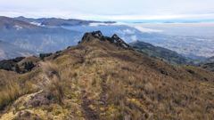 rocky ridge and distant city valley